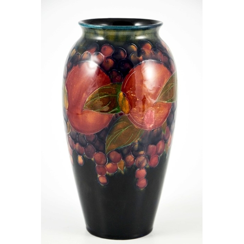 1139 - William Moorcroft, a Pomegranate on ochre and blue vase, circa 1915, ovoid form with everted rim, im... 