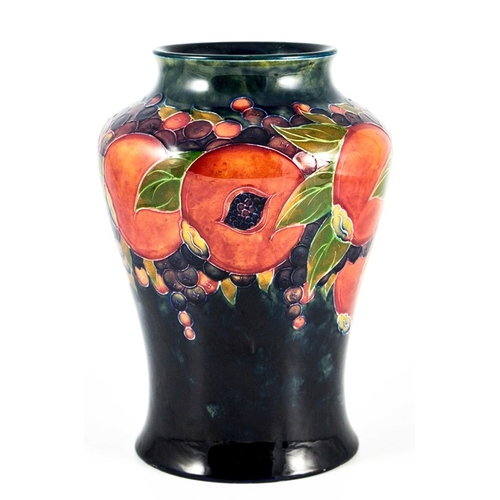 1142 - William Moorcroft, a Pomegranate on ochre and blue vase, circa 1915, inverse baluster form, impresse... 