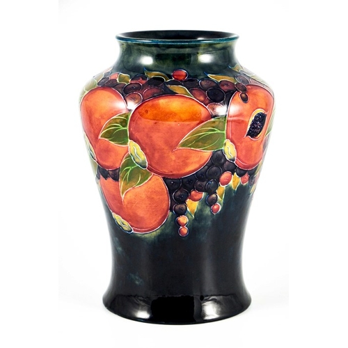 1142 - William Moorcroft, a Pomegranate on ochre and blue vase, circa 1915, inverse baluster form, impresse... 