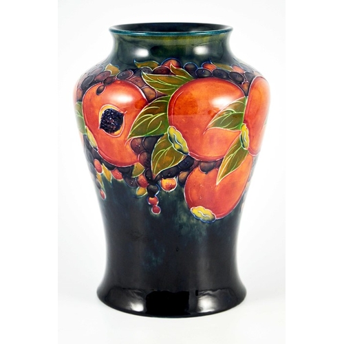 1142 - William Moorcroft, a Pomegranate on ochre and blue vase, circa 1915, inverse baluster form, impresse... 