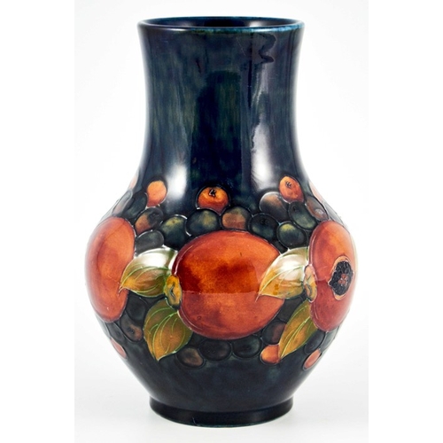 1144 - William Moorcroft, a Pomegranate on blue vase, circa 1928, straight necked baluster form, impressed ... 