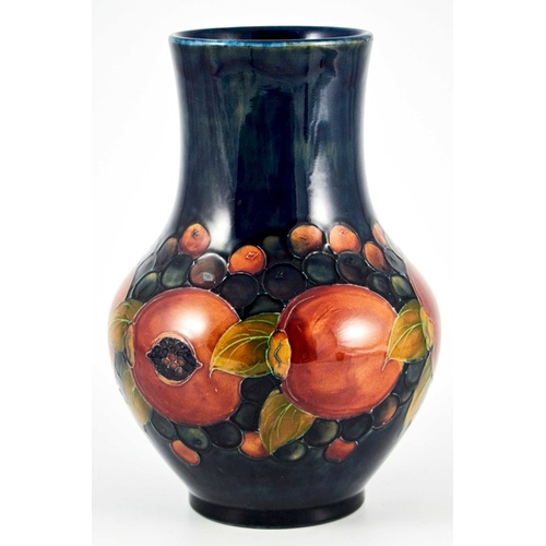 1144 - William Moorcroft, a Pomegranate on blue vase, circa 1928, straight necked baluster form, impressed ... 