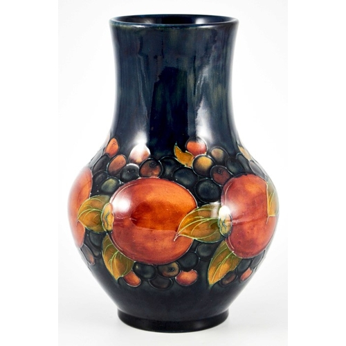 1144 - William Moorcroft, a Pomegranate on blue vase, circa 1928, straight necked baluster form, impressed ... 