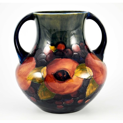 1145 - William Moorcroft, a Pomegranate on ochre and blue vase, circa 1920, twin handled amphora form, impr... 