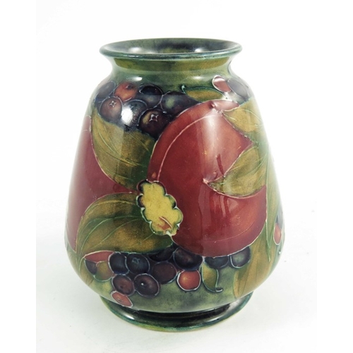 1161 - William Moorcroft, a Pomegranate on ochre vase, dated 1913, squat conical shouldered form, painted g... 