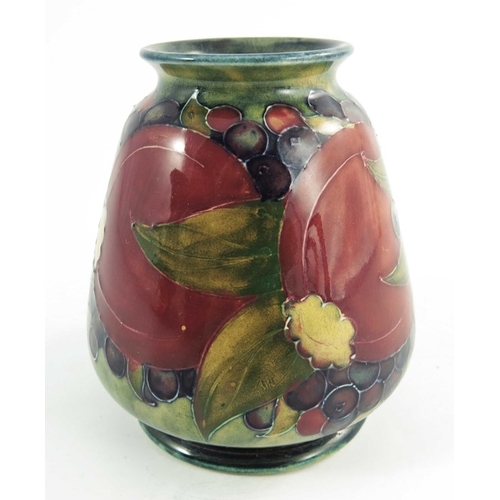 1161 - William Moorcroft, a Pomegranate on ochre vase, dated 1913, squat conical shouldered form, painted g... 