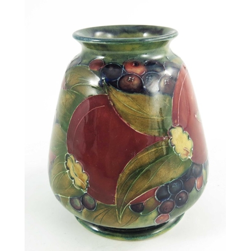 1161 - William Moorcroft, a Pomegranate on ochre vase, dated 1913, squat conical shouldered form, painted g... 