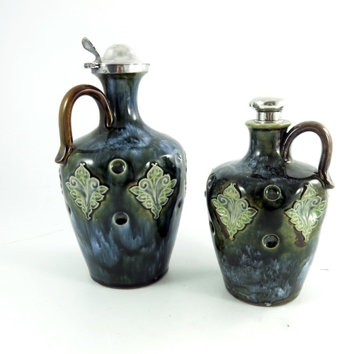 1233 - Two Doulton Lambeth stoneware whisky flagons, circa 1903, each of shouldered form, with dimpled and ... 