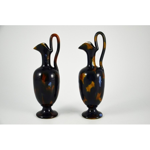 1246 - Bourne Denby, a pair of tortoiseshell stoneware ewers, circa 1860, pedestal ovoid form with elongate... 