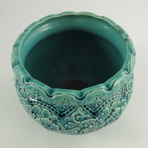 1253 - A Burmantofts Faience Jardiniere and Stand, the turquoise glazed moulded floral and leaf decorated j... 