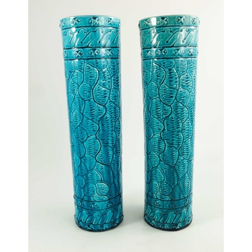 1254 - A Pair of Burmantofts Faience Turquoise Glazed Cylindrical Vases, circa 1880, decorated in low relie... 