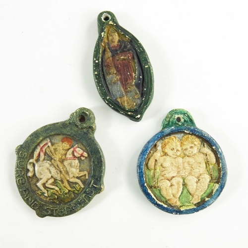 1261 - Mary Watts for Compton Pottery, three ceramic pendants, relief moulded, including St Nicholas, St Ge... 