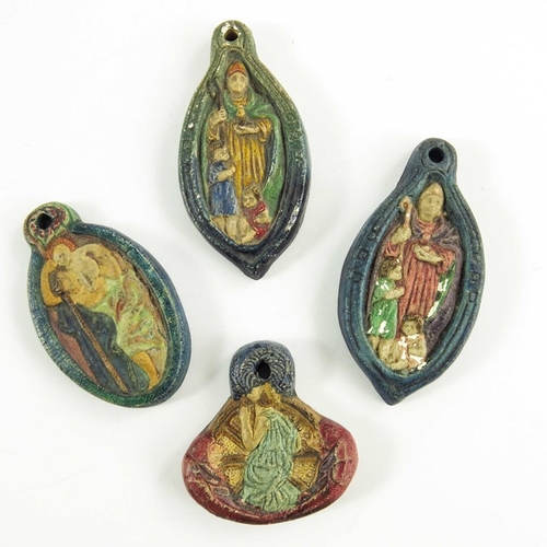 1262 - Mary Watts for Compton Pottery, four ceramic pendants, relief moulded, including St Christopher, St ... 