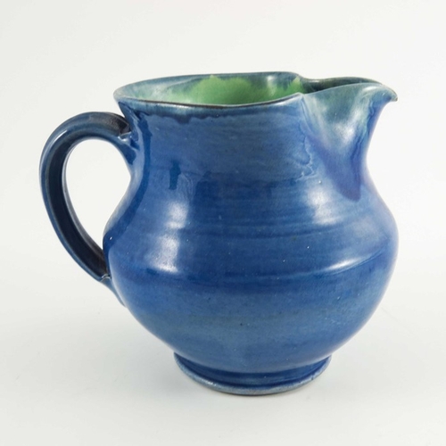 1265 - William Fishley Holland, two art pottery jugs, circa 1930, baluster form, glazed in blue and green, ... 