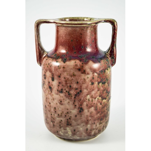 1342 - A Ruskin high fired twin handled vase, circa 1925, cylindrical shouldered form with angled handles, ... 