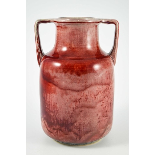 1343 - A Ruskin high fired twin handled vase, circa 1925, cylindrical shouldered form with angled handles, ... 