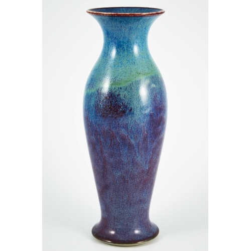 1352 - A Ruskin high fired vase, 1913, shouldered elongated baluster form, blue draining to purple, impress... 