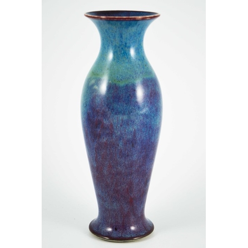 1352 - A Ruskin high fired vase, 1913, shouldered elongated baluster form, blue draining to purple, impress... 