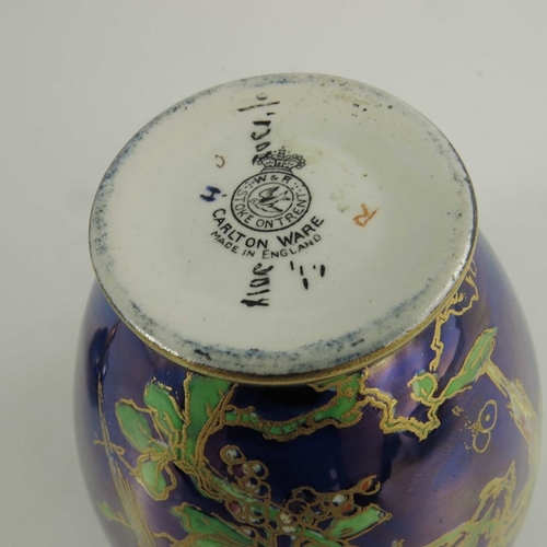 1385 - A Carlton Ware lustre temple jar and cover, ovoid form, decorated with parrots in fruiting trees, 18... 