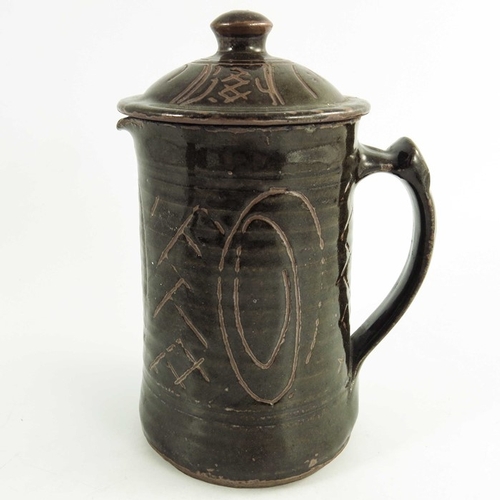 1412 - Michael Cardew for Wenford Bridge, a studio pottery jug and cover, incised with spiral and crosshatc... 