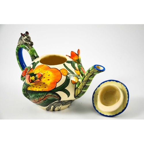 1415 - Ardmore Studio, a South African pottery teapot, 2002, relief moulded and painted with zebras and flo... 