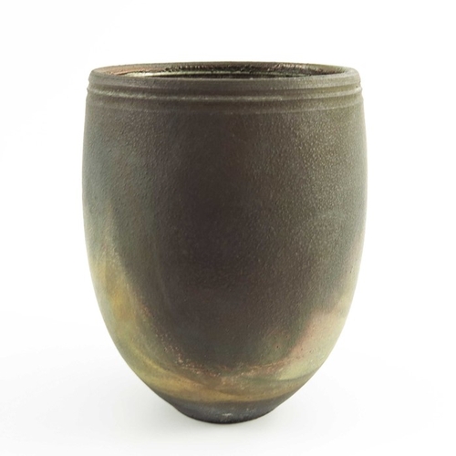 1425 - Simon Rich, a studio pottery fumed raku vase, rounded beaker form with incised band to rim, gold lus... 