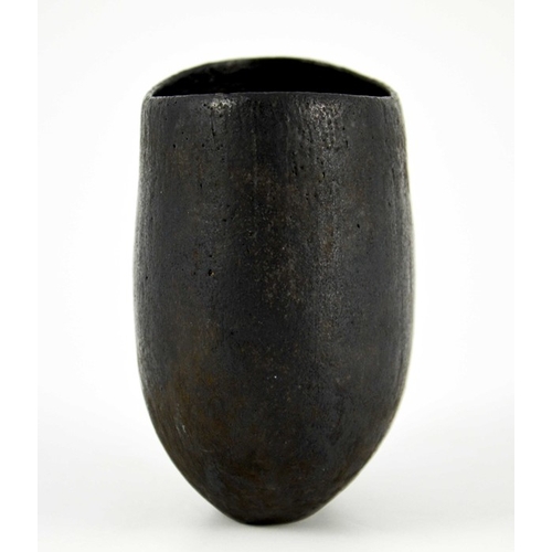 1433 - John Ward, a studio pottery vase, flattened ovoid form, black glazed, impressed seal mark, 12cm high