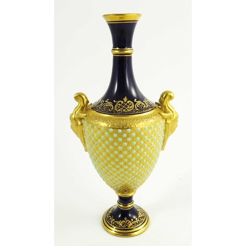 1434 - A Coalport jewelled vase, 1891, pedestal urn form, relief moulded horned handled, the gilt body with... 