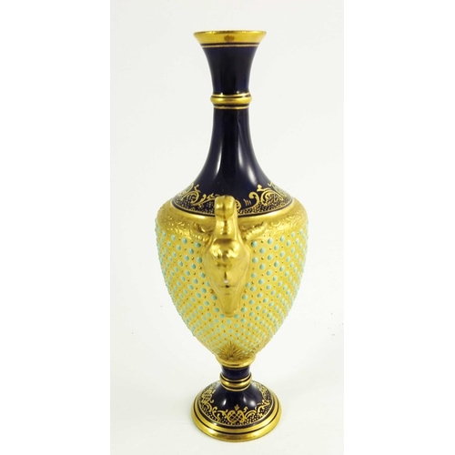 1434 - A Coalport jewelled vase, 1891, pedestal urn form, relief moulded horned handled, the gilt body with... 