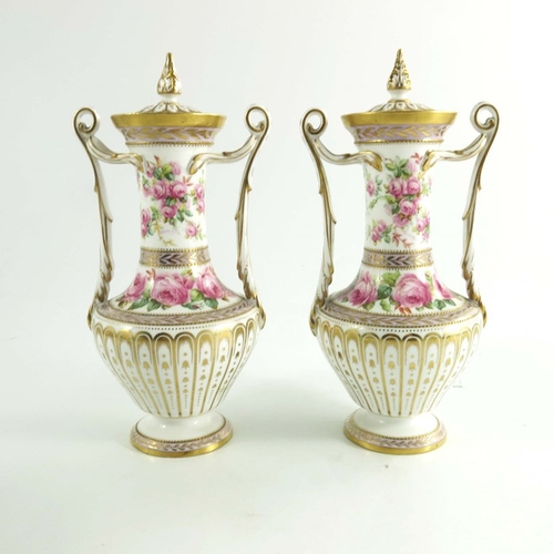 1435 - A pair of Spode Copeland vases, circa 1920, baluster form with twin handles, hand painted with spray... 