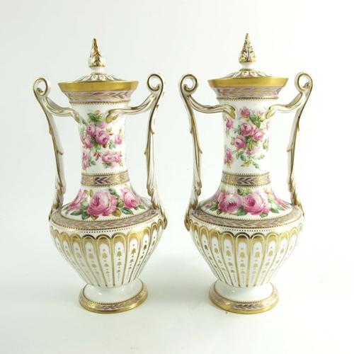 1435 - A pair of Spode Copeland vases, circa 1920, baluster form with twin handles, hand painted with spray... 