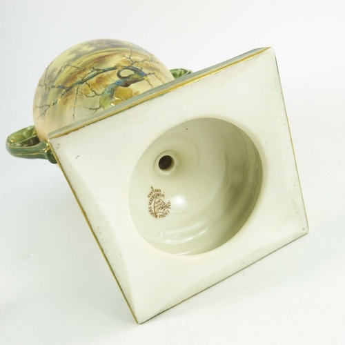 1448 - A Royal China Works, Worcester blush ivory ground with green highlights, twin handled urn and cover ... 