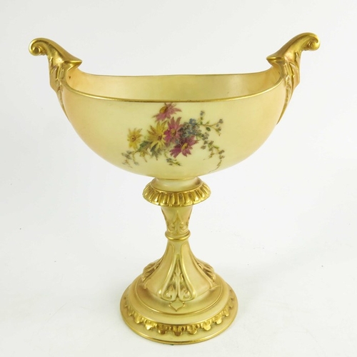 1455 - A Royal Worcester blush ivory oval pedestal vase, the oval boat shape body raised on a fluted, gilt ... 