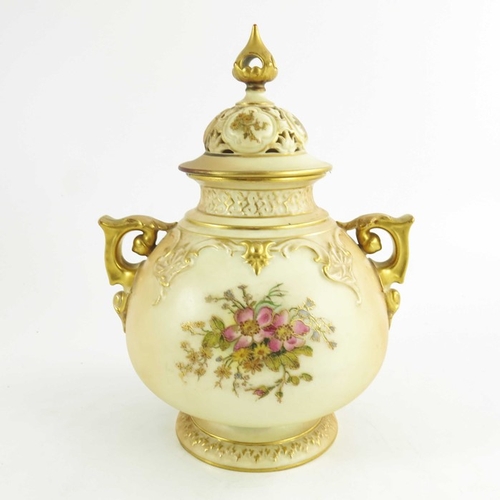 1458 - A Royal Worcester blush ivory ground globular pot pourri two handled jar and cover, decorated with d... 