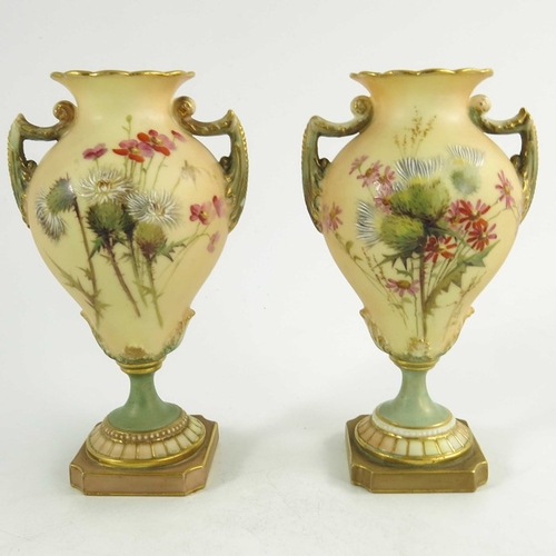 1460 - A pair of Royal Worcester miniature blush ivory ground two handled vases, florally decorated with th... 