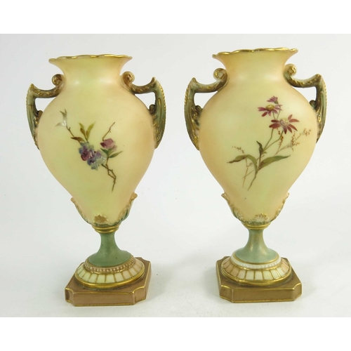 1460 - A pair of Royal Worcester miniature blush ivory ground two handled vases, florally decorated with th... 