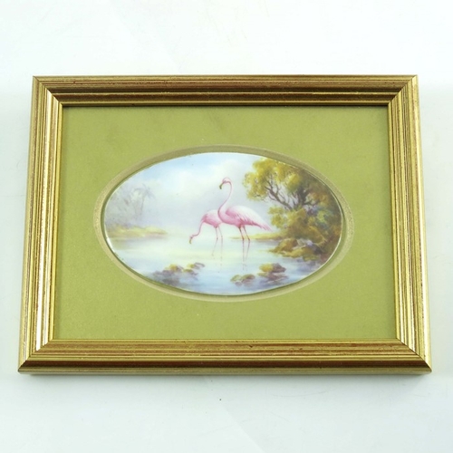 1498 - C Johnson for Royal Worcester, an oval plaque, 1913, painted with flamingos in a lake, 9.5cm wide