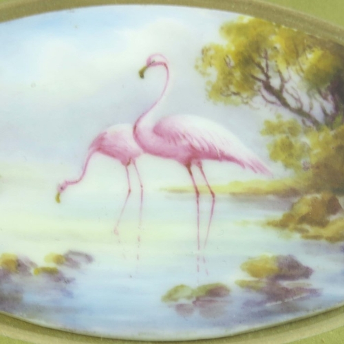 1498 - C Johnson for Royal Worcester, an oval plaque, 1913, painted with flamingos in a lake, 9.5cm wide