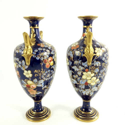 1502 - A pair of Crown Derby vases, circa 1920 twin handle pedestal form, painted flowers and foliage with ... 