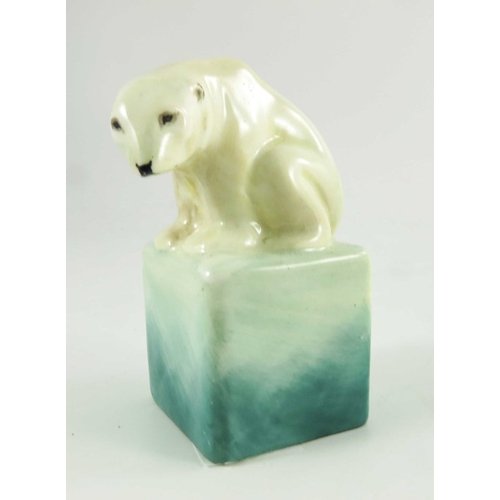 1509 - A Royal Doulton figure, circa 1920, a polar bear on a cube, 10cm high