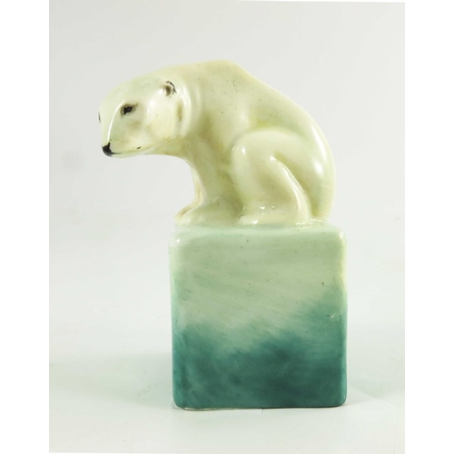 1509 - A Royal Doulton figure, circa 1920, a polar bear on a cube, 10cm high