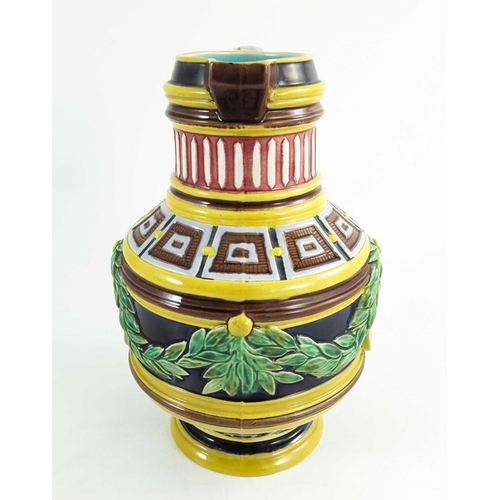 1513 - A Wedgwood majolica jug, circa 1870, cylindrical baluster form, relief moulded with classical portra... 