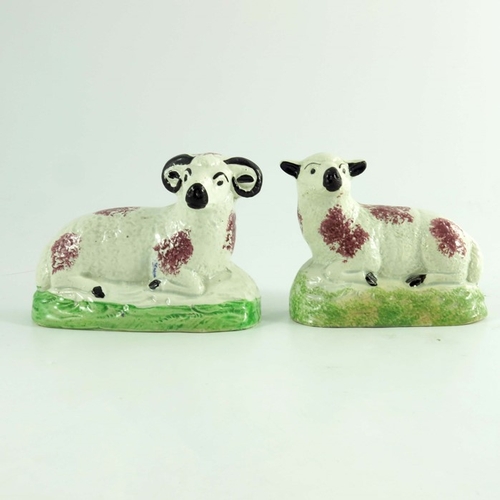 1528 - A pair of Scottish pottery figures of a ram and ewe, circa 1820, modelled sitting, sponge decorated,... 