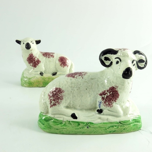 1528 - A pair of Scottish pottery figures of a ram and ewe, circa 1820, modelled sitting, sponge decorated,... 