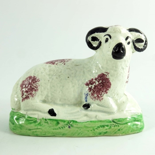 1528 - A pair of Scottish pottery figures of a ram and ewe, circa 1820, modelled sitting, sponge decorated,... 