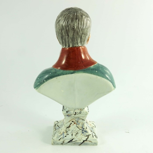 1529 - A Staffordshire bust of Napoleon, circa 1820, modelled in green uniform on a marbled plinth, 28cm hi... 