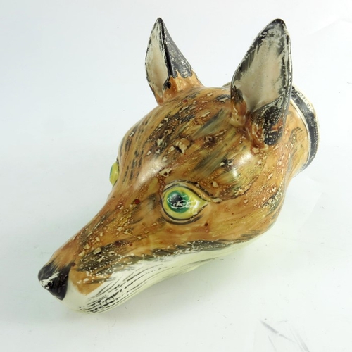 1533 - A Staffordshire fox mask creamware stirrup cup, circa 1790, painted in realistic colours, 17cm long