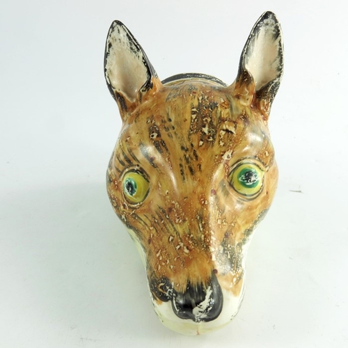 1533 - A Staffordshire fox mask creamware stirrup cup, circa 1790, painted in realistic colours, 17cm long