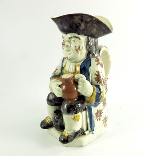 1534 - A Staffordshire Toby jug, circa 1790, sponge decorated in Prattware colours, modelled with jug of be... 