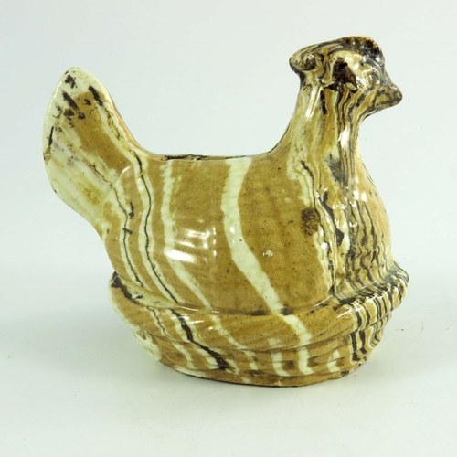 1566 - A Staffordshire agate ware money box, modelled as a hen, circa 1820, sitting in a basket, 10cm high